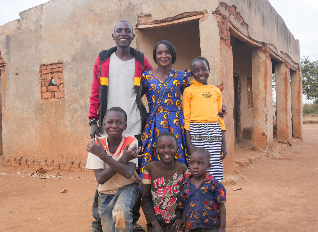 Dorika (top center) models a dress that she created herself — showing her neighbors the high level of skill and expertise that she brings to her business.