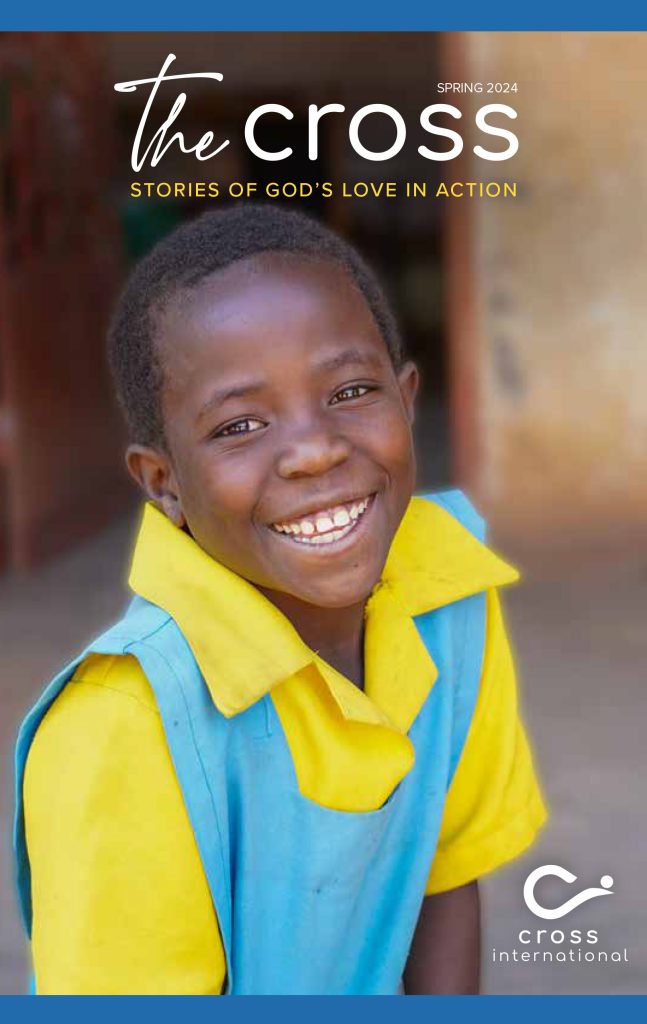 Magazine Cover: nine-year-old Esther from Malawi smiling to the camera