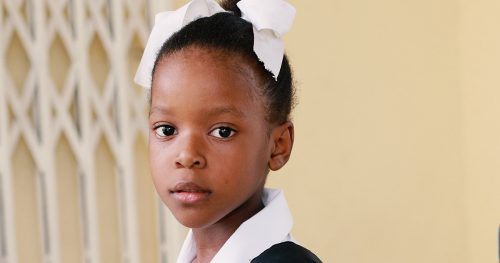 Seven-year-old Christ-Naïda in her school clothes.